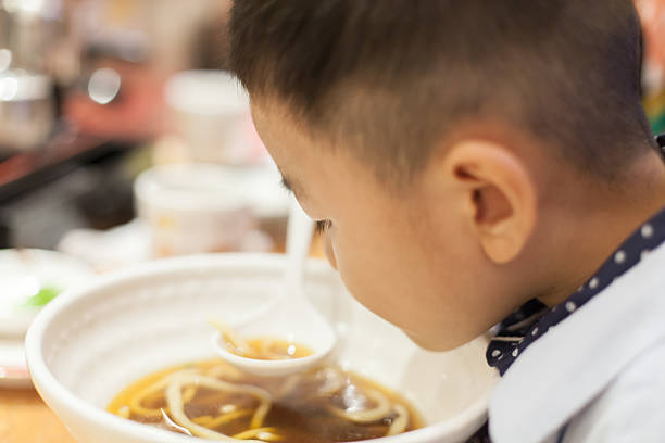 istock Asian child eat food 586932568