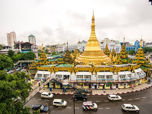 Yangon, Myanmar - August 12, 2013: Traffic passing through the street outside Sule Paya in Yangon, Myanmar.