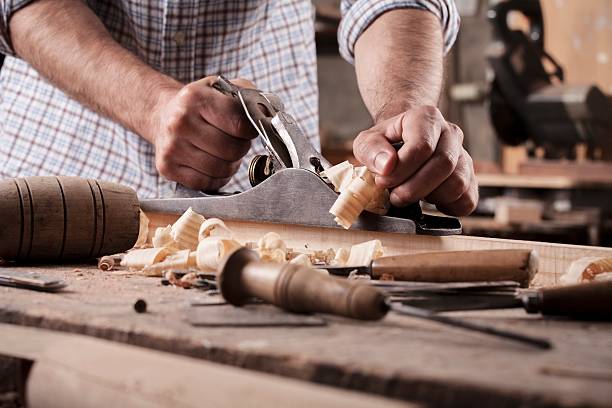 istock carpenter working with plane on wooden background 586932762