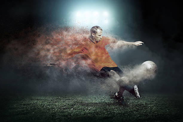 istock Football player with ball around splash drops on the stadium 586934038