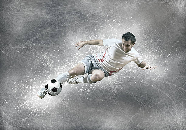istock Football player with ball in action under sky with clouds 586934042