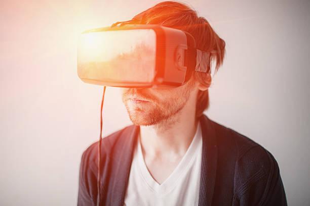 istock selective focus on face. Handsome man wearing virtual reality glasses 586934796