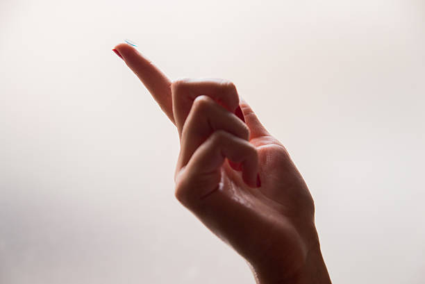 medicine and vision - womans finger with contact lens - lens contact lens glasses transparent imagens e fotografias de stock