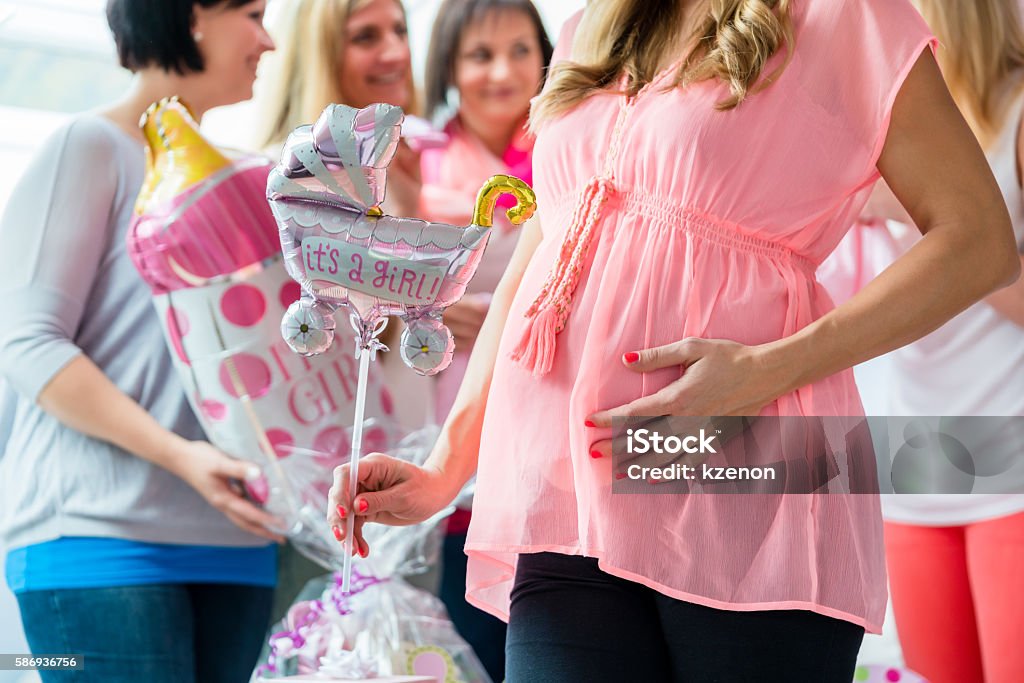 Pregnant Woman on baby shower party Pregnant Woman on baby shower party  showing her baby belly Baby Shower Stock Photo