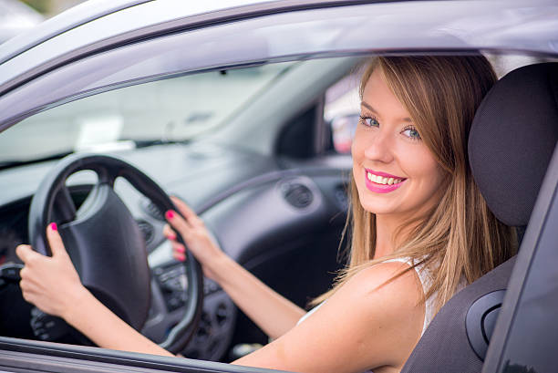 istock Smiling woman sitting in car 586936774
