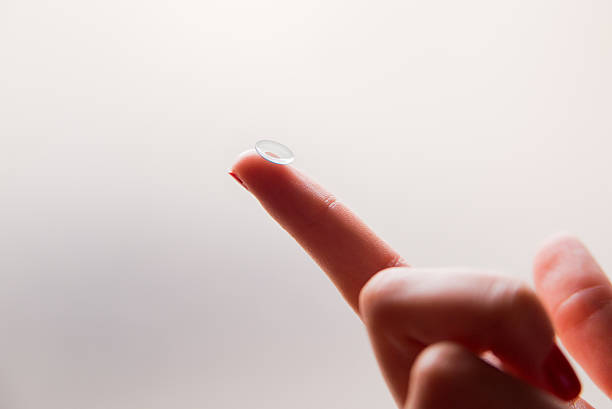istock Holding a softlense, closeup, Contact lens on finger 586936914