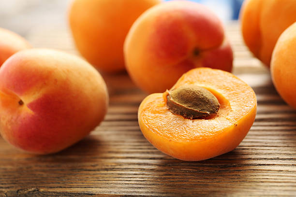 istock Ripe apricots fruit on grey wooden table 586937616
