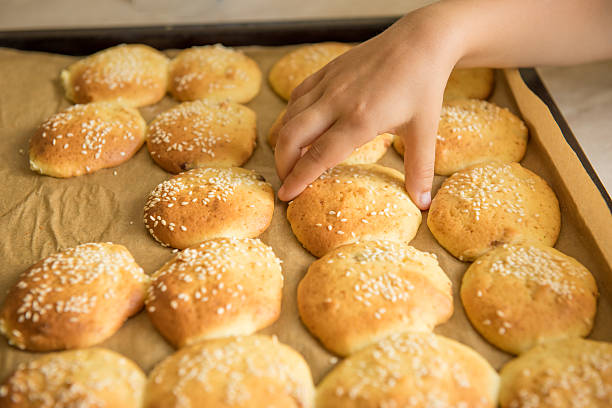 istock Homemade cookies on dripping pan. Hand takes 586938868