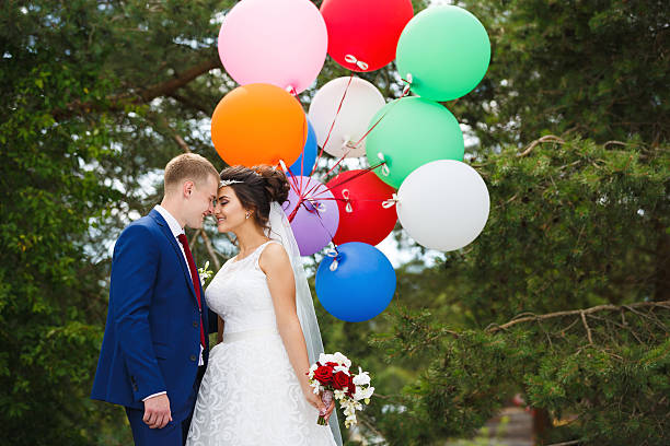 istock Happy couple with colored balloons 586939168