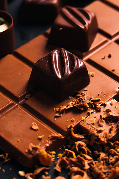istock Many candy and chocolate chips on a black background 586940446