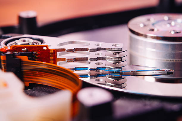 istock Internal hard disk closeup on wooden background 586941418