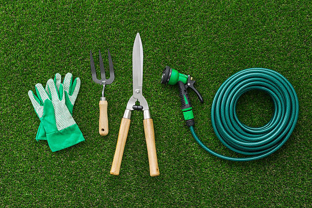 Gardener tools Gardener tools on the grass, hobby and gardening concept, flat lay garden hose stock pictures, royalty-free photos & images