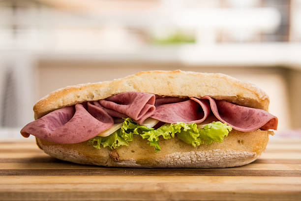 istock Ham sandwich on a wooden surface 586943038