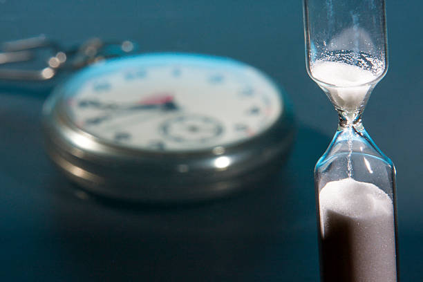 istock Hourglass and pocket watch 586945424