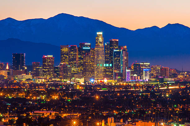 Downtown Los Angeles skyline at dawn with Mount Baldy (a.k.a. Mount San Antonio) in the background.