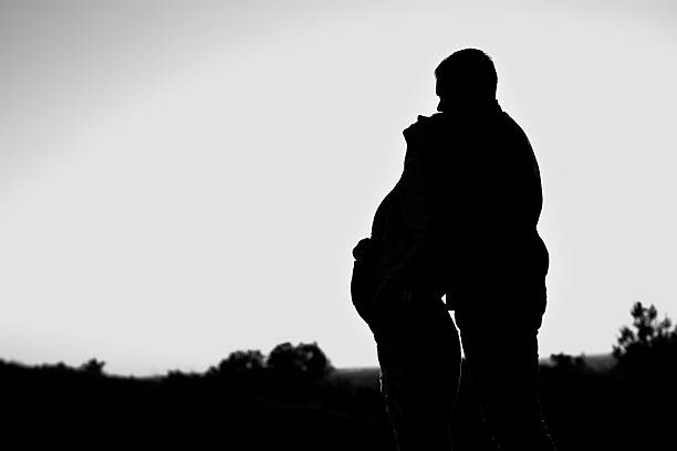 istock Pregnant couple silhouettes 586945806