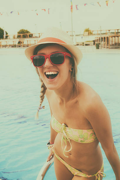 istock Young girl at the swimming pool. 586946082