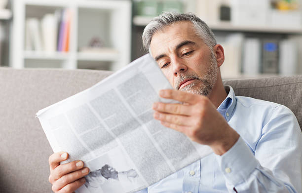 istock Businessman reading a newspaper 586946386