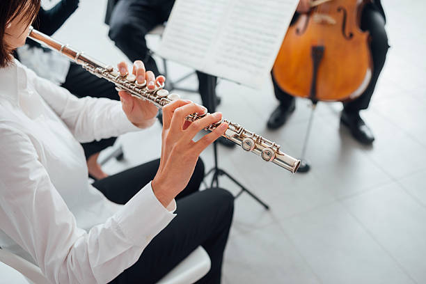 istock Flutist playing her instrument on stage 586946964
