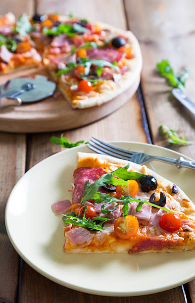 istock Pizza with salami, cherry tomatoes and arugula 586947718