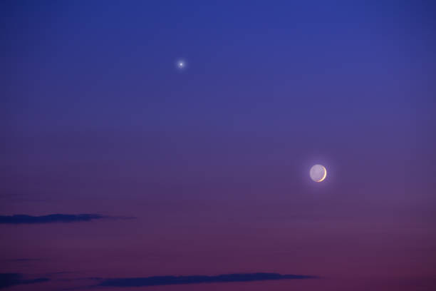 istock Moon and Venus on a twilight sky. 586947898