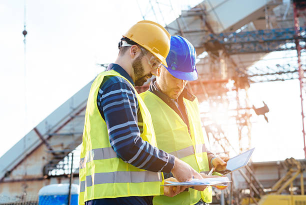 istock Main engineer showing report to contractor at construction site 586948260