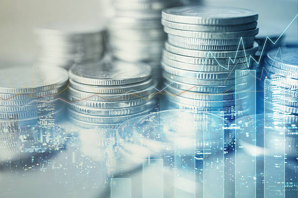 istock Double exposure of graph and rows of coins 586949390