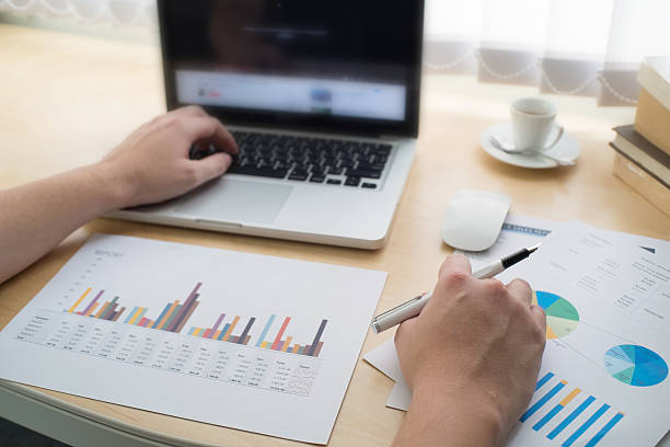 istock Business man use on-line via laptop computer for analyzing finan 587183914