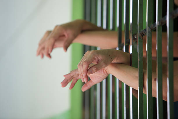 istock hand of prisoner in jail 587184892