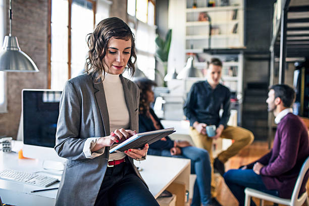 istock Creative businesswoman at the office with digital tablet 587185202