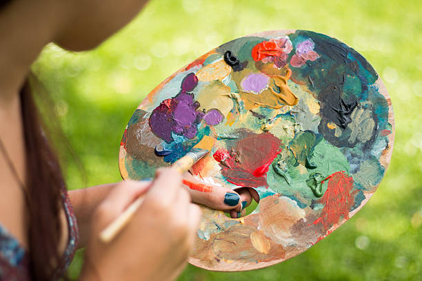 istock Artist painting, holding palette 587188312