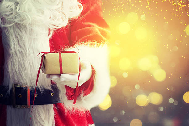 istock Santa Claus gloved hands holding giftbox 587188796