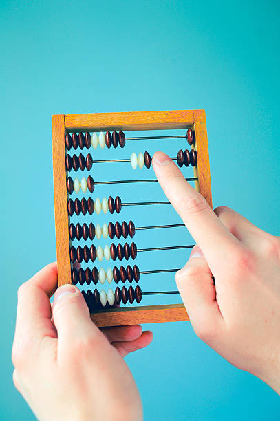istock accountant calculating with wooden numerator 587188900