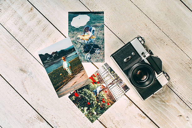 istock Retro film camera with retro photos 587189178
