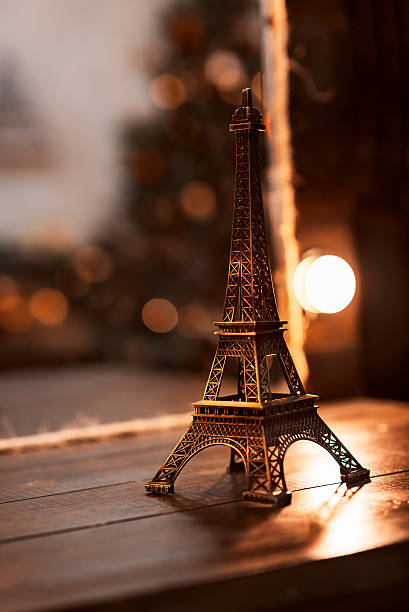 istock Miniature Eiffel-tower with defocused spot lights in background 587190228