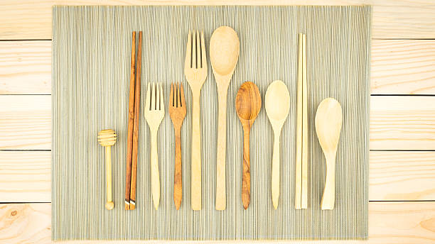 istock Wooden spoon and fork, chopsticks, spoon honey with bamboo mat. 587191074