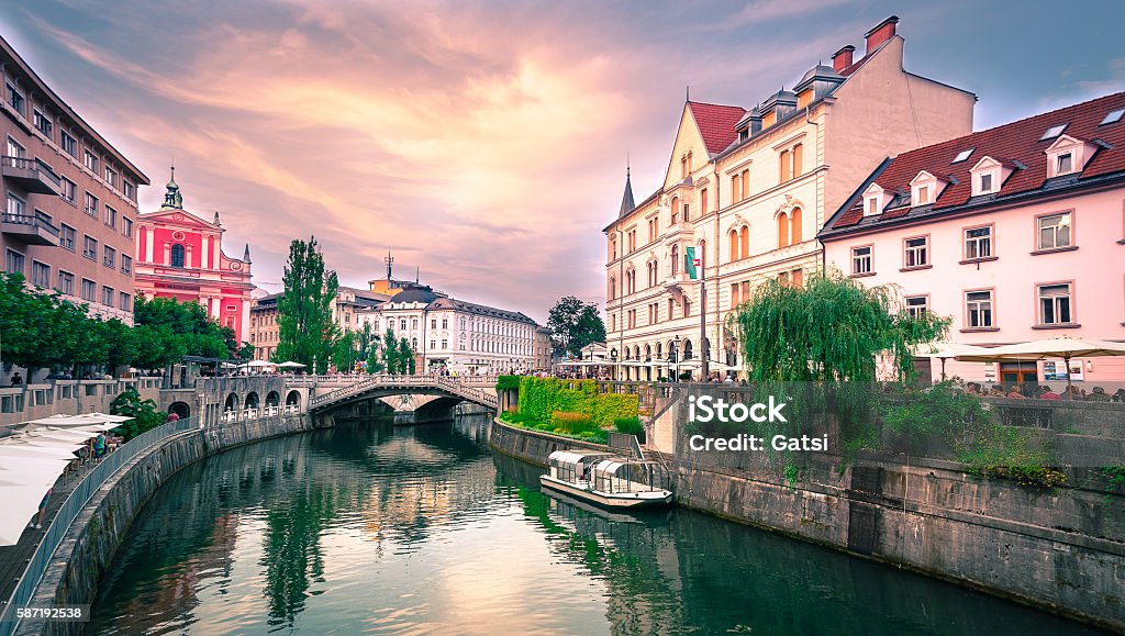 Slovenia Ljubljana Tromostovje Ljublianica river Church Slovenia Ljubljana Tromostovje Ljublianica river Church with bridge and boat. Ljubljana Stock Photo