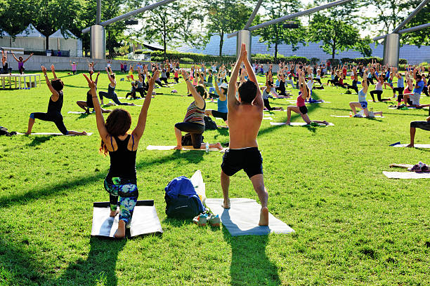 Tai Chi Class, Millennium Park, Chicago Chicago, USA - August 6, 2016: Tai Chi session (energy, wellness, balance) in Milllennium Park, downtown Chicago. Many people, early morning exercise. millennium park stock pictures, royalty-free photos & images