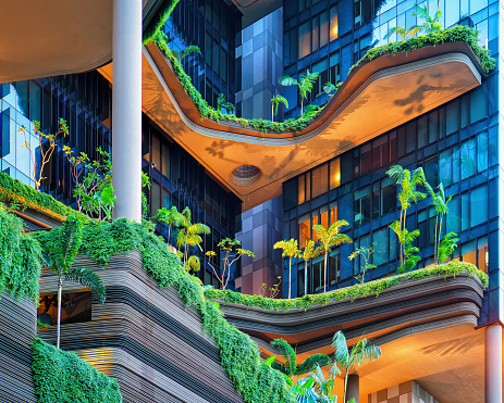 Singapore, Singapore - March 1, 2016: Modern architecture of a building balcony with much green plants. Modern design in the center of Singapore.