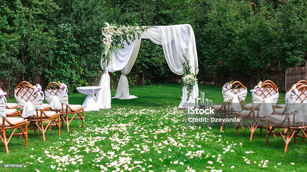 Beautiful setting for outdoors wedding ceremony Beautiful setting for outdoors wedding ceremony waiting for bride and groom and guests. Decoration Wedding Stock Photo
