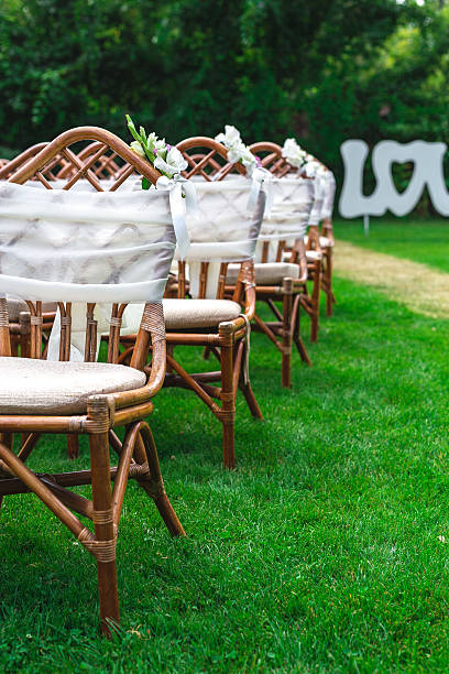 istock Wedding chairs decorated with flowers. Close up. 587198274