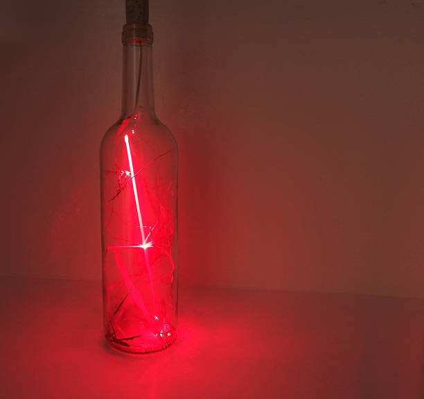 istock Glass bottle in laser abstraction 587198464