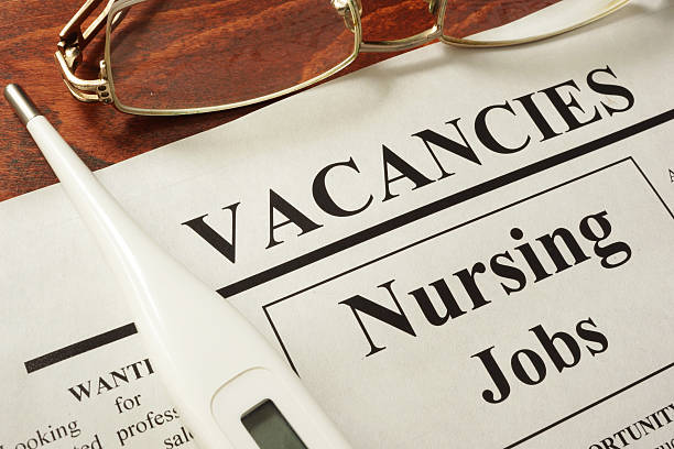 istock Newspaper with ads nursing jobs vacancy. Occupation concept. 587198758