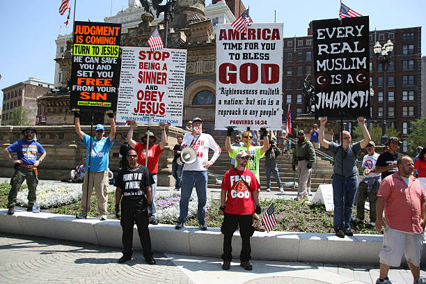 Republican National Convention, July 19, 2016 Cleveland, Ohio, USA - July 19, 2016: Members of the Westboro Baptist Church demonstrate in the Public Square on the second day of the Republican National Convention. The WBC is primarily known for its hate speech directed at the LGBTQ community, Muslims, Jews, Catholics and soldiers killed in combat defending the concept of liberal democracy and is classified as a hate group by the Anti-Defamation League and the Southern Poverty Law Center. rnc stock pictures, royalty-free photos & images