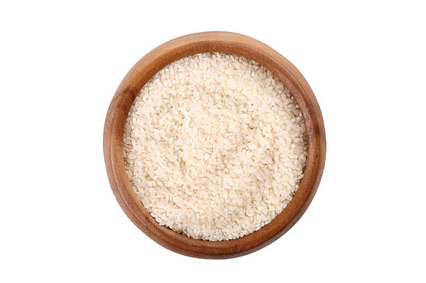 istock broken rice in a wooden bowl. 587199214
