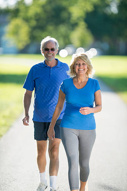 istock Couple Walking Through the Park 587199494