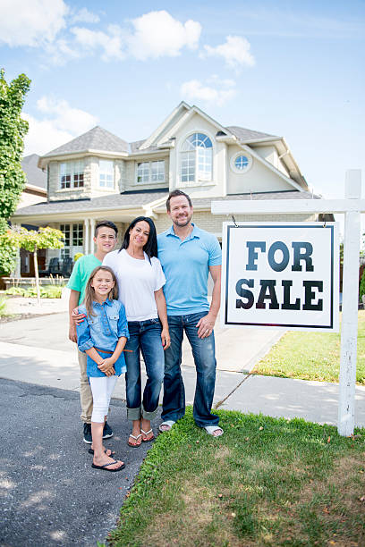 istock Family Standing by Their New Home 587200482