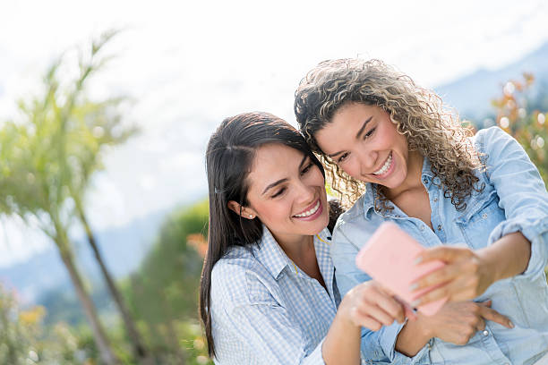 istock Happy friends social networking outdoors 587200558