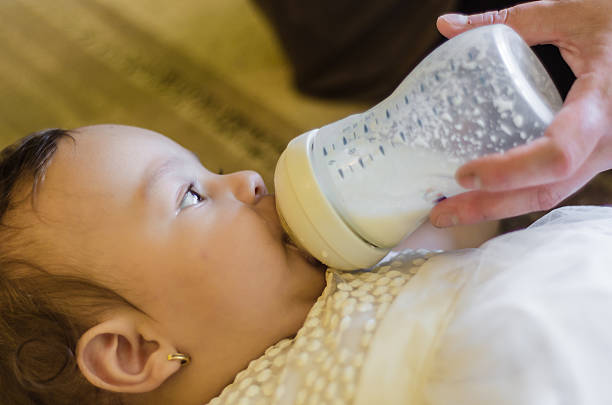 istock little baby drinking milk from a bottle 587200820