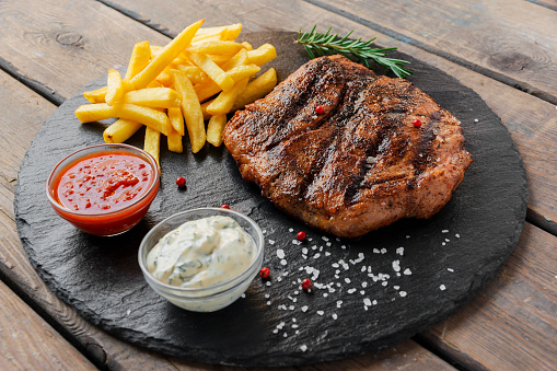 Beef steak with french fries and sauce